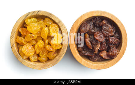 Sweet dried raisins in wooden bowl isolated on white background. Stock Photo