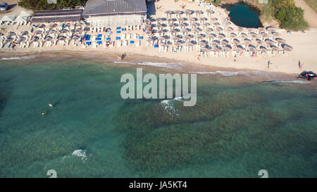 Sea at summer with sandy beach with bathers and parasols Stock Photo