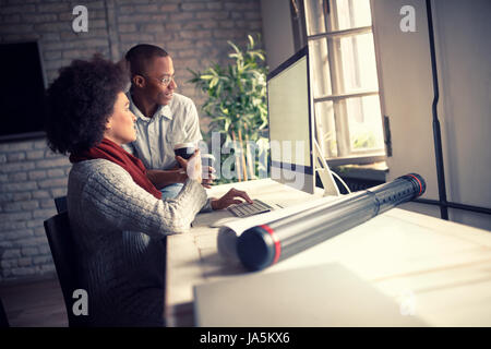 Woman with young manager at work on computer in office Stock Photo