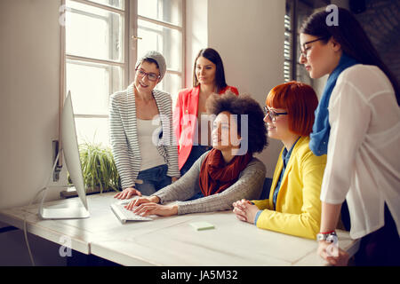 Group of designers working on computer in office Stock Photo