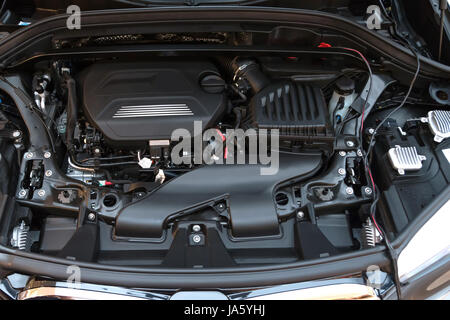 Automotive industrial part of modern new car engine room machine show all parts and open hood. Stock Photo