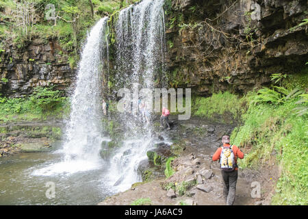 People,hiking,walk,behind,beneath,waterfall,Sgwd yr Eira,Waterfall of the Snow,Afon Heptse,river,Powys,Brecon Beacons,National,Park,Wales,Welsh,U.K,UK Stock Photo