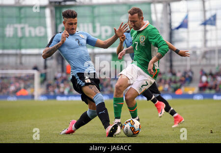 Uruguay's Jose Maria Gimenez and Republic of Ireland's Aiden McGeady battle for the ball during the international friendly at The Aviva Stadium, Dublin. Stock Photo