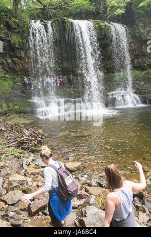 People,hiking,walk,behind,beneath,waterfall,Sgwd yr Eira,Waterfall of the Snow,Afon Heptse,river,Powys,Brecon Beacons,National,Park,Wales,Welsh,U.K,UK Stock Photo