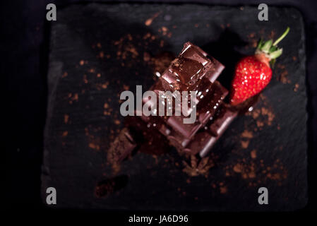 One red straberry on a dark  chocolate Stock Photo