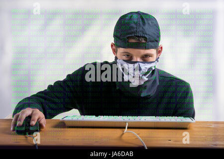 hacker using the computer, young man using the computer, programmer with lines of code, hacking Stock Photo