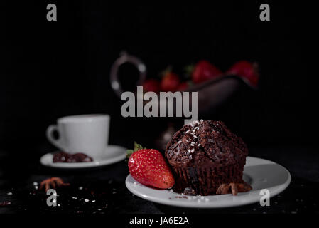 Coffee with muffin on a black background Stock Photo