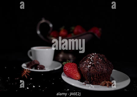 Coffee with muffin on a black background Stock Photo