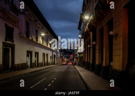 Street of Quito and Basilica del Voto Nacional at night - Quito, Ecuador