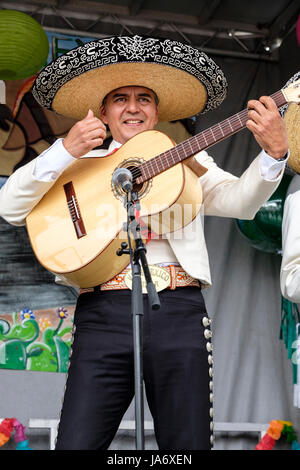 Live music. Male Mexican mariachi acoustic guitar player wearing a sombrero hat performing at a Mexican music festival, mariachi singer, mariachi guitar, Mexican musician, mariachi male, mariachi music. Stock Photo