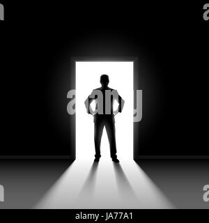 Silhouette of a male entering a dark room with a shaft of light Stock ...