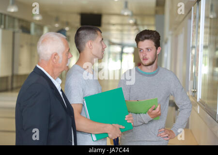 students in university corridor near window Stock Photo