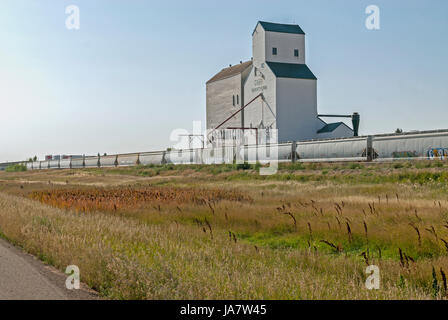 Grain elevator next to railway cars Stock Photo