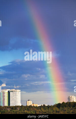 urban house under rainbow in dark blue sky Stock Photo