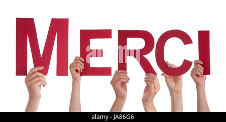 Many Hands Holding the French Word Merci, Which Means Thanks, Isolated Stock Photo