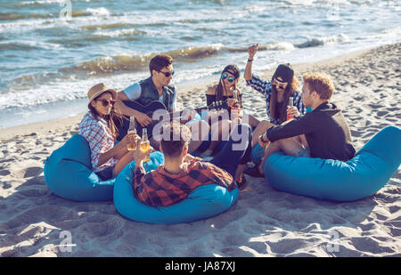 group of friends drinking on the beach party Stock Photo