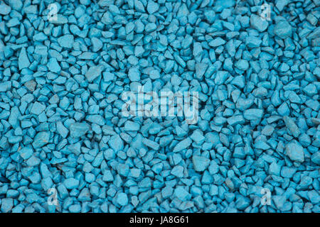 Background of blue gravel for decoration. Painted decorative stones, selective focus closeup Stock Photo