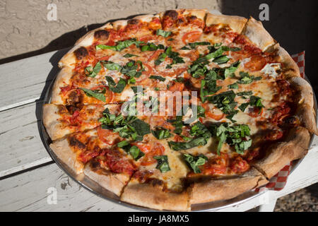 Margarita pizza pie on a white bench Stock Photo