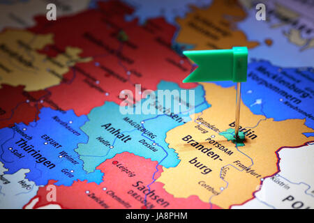 Closeup of Germany map with flag pin at Berlin point Stock Photo