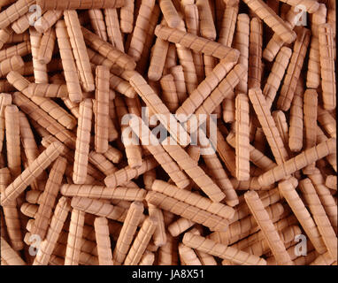 This is a close-up view of small wooden dowels that are used in furniture making.  This photo could be used a a textured background for another image. Stock Photo