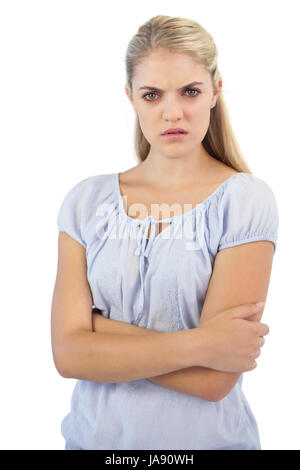 Outraged blonde woman  with arms crossed on white background Stock Photo