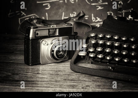 Old vintage retro camera with an old-fashioned typewriter Stock Photo