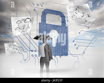 Businessman under an umbrella looking at a giant padlock with drawings floating around Stock Photo