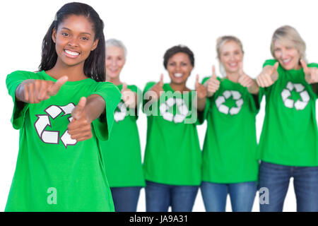 Team of female environmental activists smiling at camera and giving thumbs up on white background Stock Photo