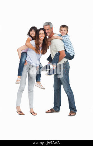 Parents holding their children on backs on white background Stock Photo