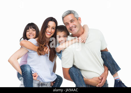 Smiling parents holding their children on backs on white background Stock Photo