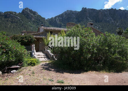 MALLORCA, SPAIN - MAY 15, 2017: Rustic building details in green subtropical garden in the Tramuntana mountains on May 15, 2017 in Mallorca, Spain. Stock Photo