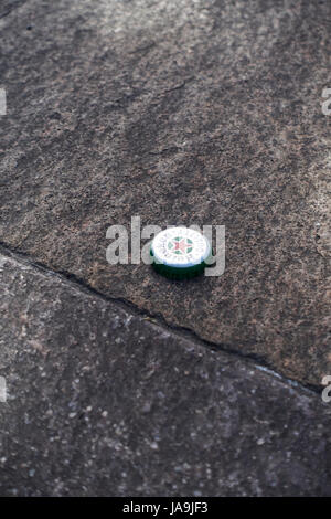 Heineken beer bottle cap on the ground, detail Stock Photo