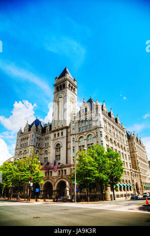 WASHINGTON, DC - MAY 8: Old Post Office pavilion with tourists in Washington, DC on May 8, 2013. It's known as Old Post Office and Clock Tower and officially renamed the Nancy Hanks Center in 1983, is a historic building of the United States federal government. Stock Photo