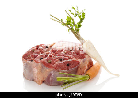Raw veal shank meat with vegetables isolated. Ossobucco steak eating. Stock Photo