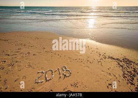2018 New Year text made using shells on sand at Glenelg beach Stock Photo