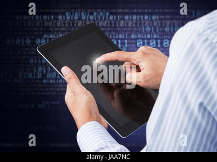 Businessman holding digital tablet on binary background Stock Photo