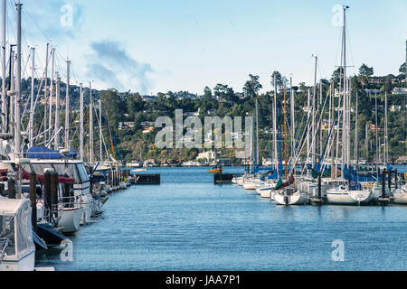 Sail boats docked in Sausalito, California. Sausalito is located just across the bay from San Francisco. On the other side in the distance in Tiburon, Stock Photo