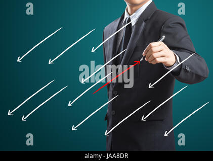 Businessman drawing arrows in different directions Stock Photo