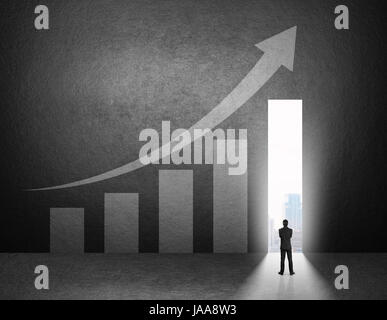 Silhouette of businessman stand in front of the growth chart on the wall Stock Photo