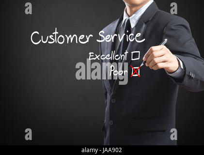 Hand putting check mark on poor customer service evaluation form Stock Photo