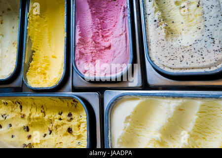 On overhead view of tubs of various flavours of ice cream Stock Photo