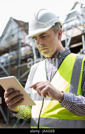 Architect On Building Site Using Digital Tablet Stock Photo