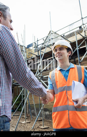 Customer On Site Shaking Hands With Builder Stock Photo