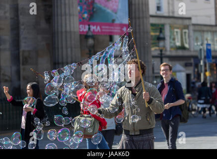 A street entertainer in Edinburgh blowing bubbles Stock Photo