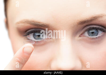Pretty model on white background holding contact lens Stock Photo