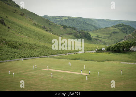 Match play on the pitch during an annual friendly match between Cravens Cavaliers and Lynton & Lynmouth Cricket Club at their ground based inside the Valley of Rocks, North Devon. Stock Photo
