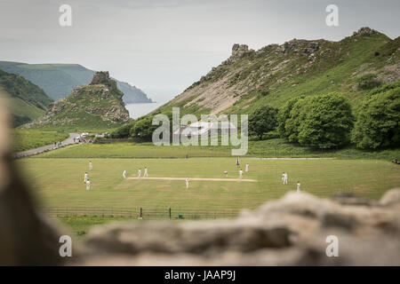 Match play on the pitch during an annual friendly match between Cravens Cavaliers and Lynton & Lynmouth Cricket Club at their ground based inside the Valley of Rocks, North Devon. Stock Photo
