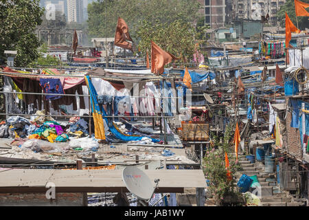 Editorial: MUMBAI, MAHARASHTRA, INDIA, April 12, 2017 - Laundry piled up on roofs in the Mahalaxmi Dhobi Ghat open air laundromat in Mumbai Stock Photo