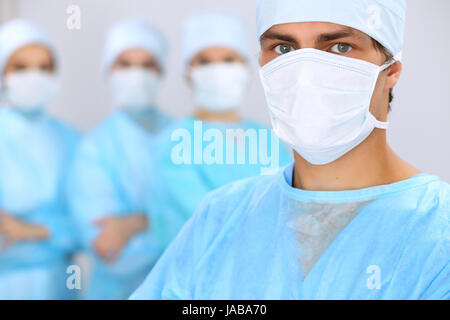 Medical team performing operation. Focus on male surgeon. Stock Photo