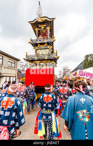 Inuyama festival in Japan, massive 3 storey wooden Dashi float, also called yatai or yama, in city square with spectators and Dashi team members. Stock Photo